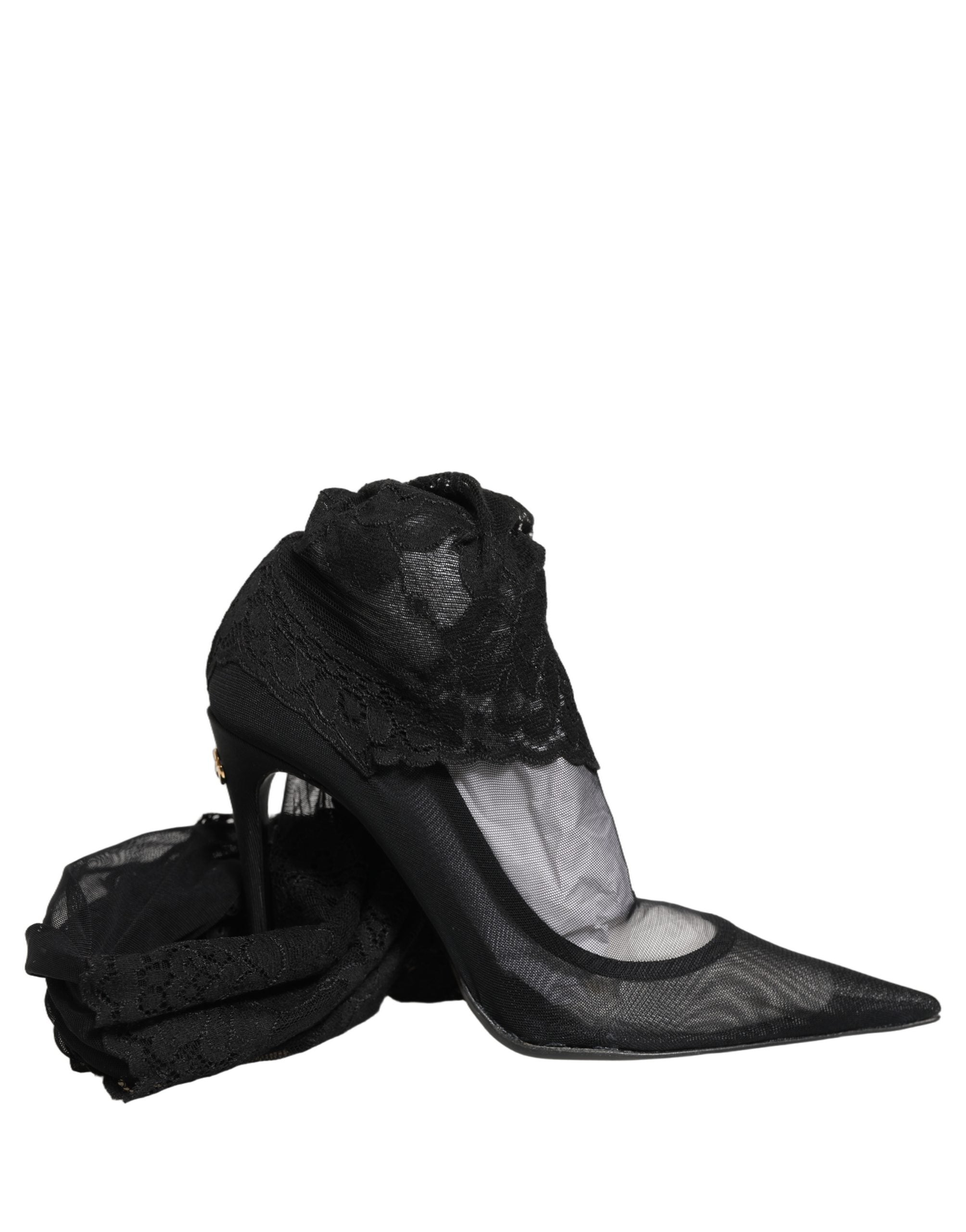 Bottes Dolce & Gabbana noires, cuissardes, avec semelle élégante et design sophistiqué, visibles en gros plan.