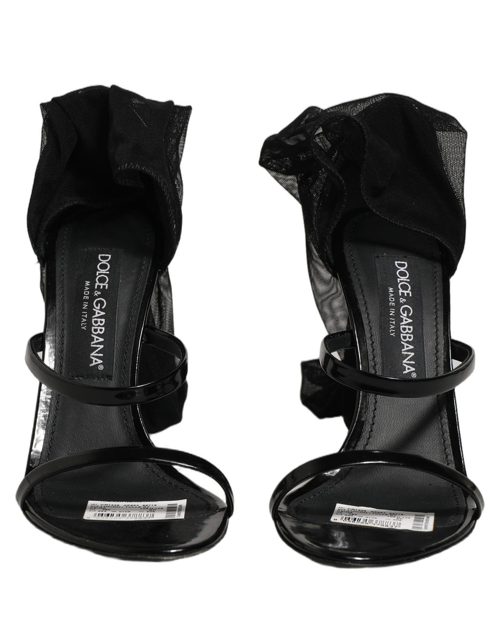 Sandales stilettos Dolce & Gabbana avec chaussettes, bottes hautes noires, mode élégante et sophistiquée visible sur l'image.