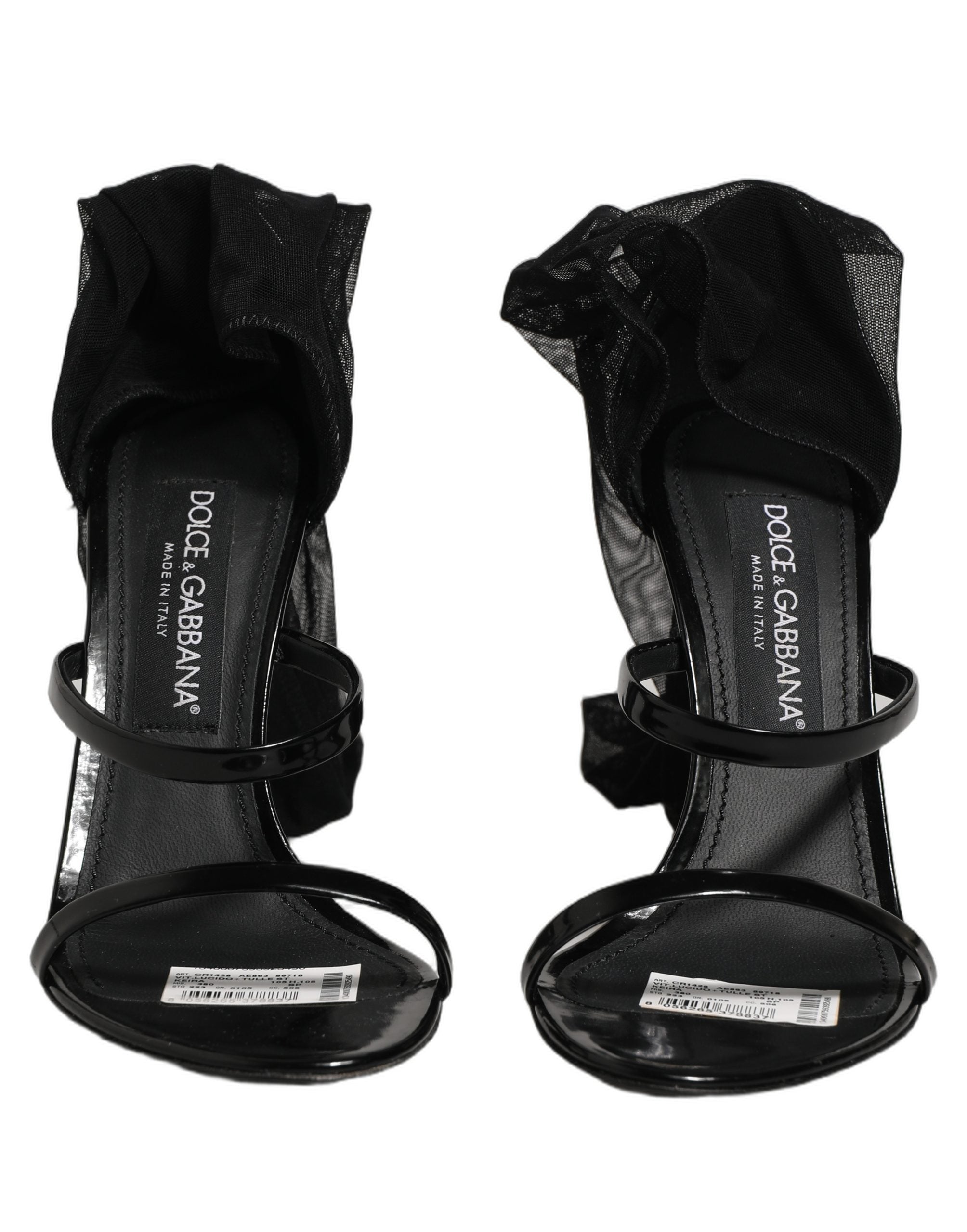 Sandales stilettos Dolce & Gabbana avec chaussettes, bottes hautes noires, mode élégante et sophistiquée visible sur l'image.