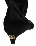 Bottes hautes en satin noir de Dolce & Gabbana, bottines à talon kitten, élégantes et sophistiquées.