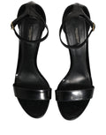 Sandales à talons noires Dolce & Gabbana en cuir avec bride à la cheville, vue de côté sur une paire élégante.