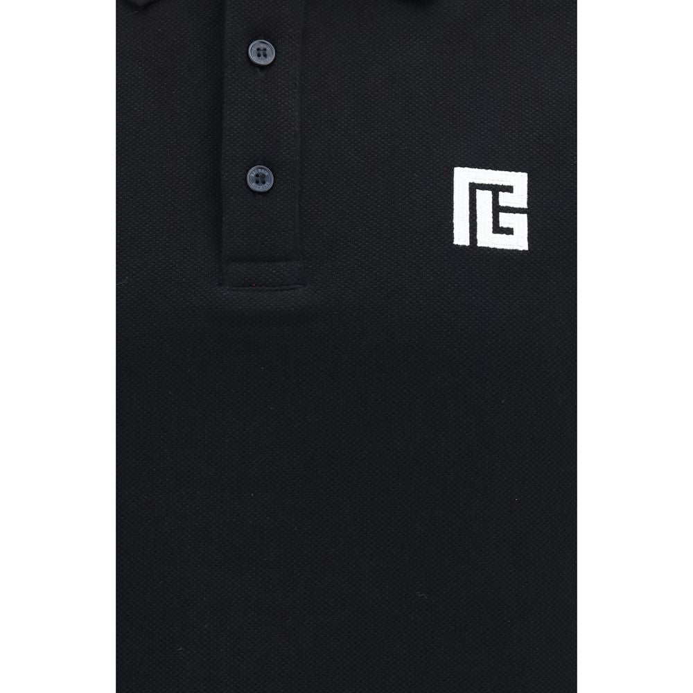 Chemise polo noire en coton Balmain, vista frontale montrant le col et les boutons, style élégant et moderne.