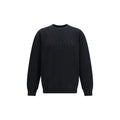 Sweatshirt en coton noir Balmain, décontractée, avec logo visible, porté sur un modèle dans un environnement lumineux.