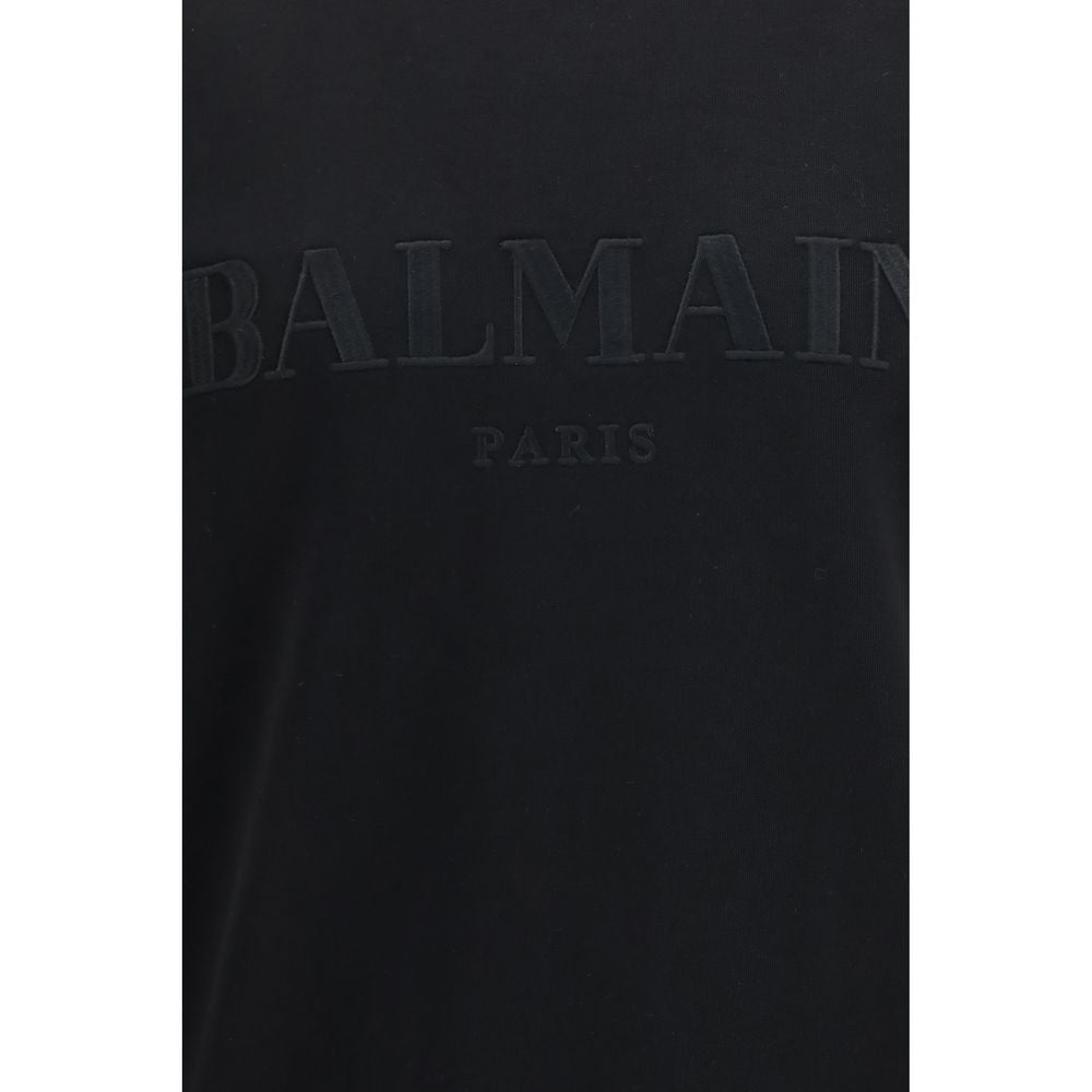 Sweat-shirt noir en coton de Balmain, coupe décontractée avec logo brodé, porté sur un mannequin blanc.