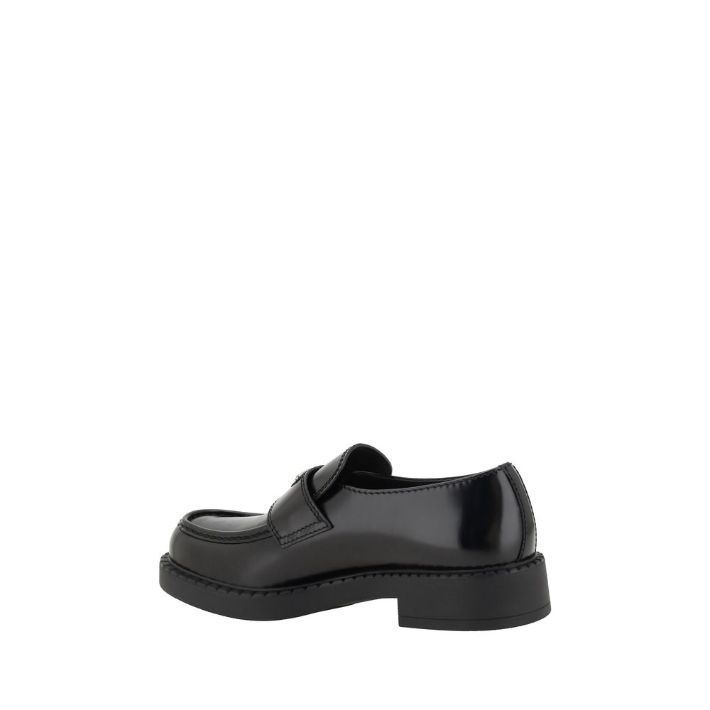 Chaussures Prada Bos Taurus en cuir de veau noir avec plateforme, loafers élégants et sophistiqués.