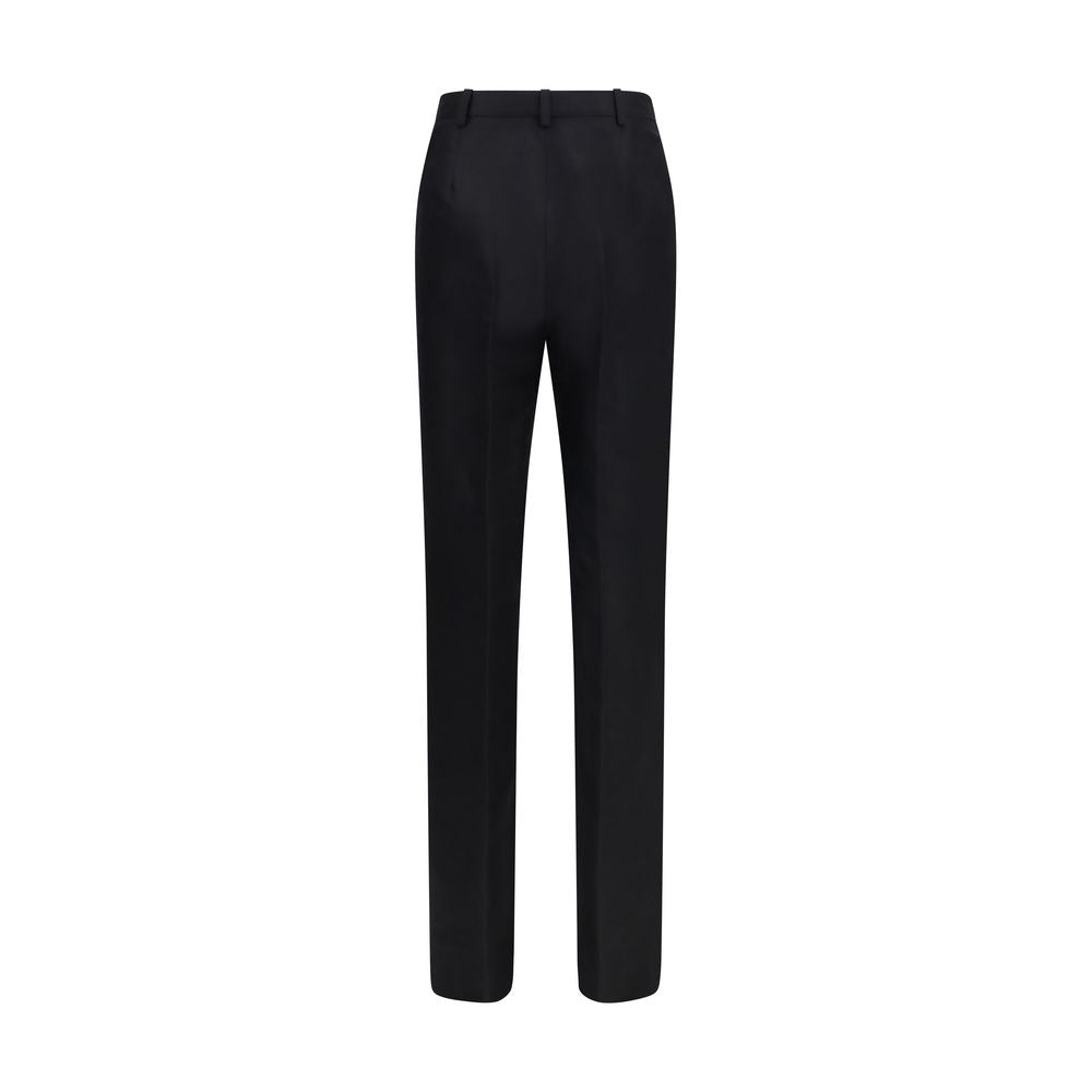 Pantalon de costume en soie noire Gucci pour femme, coupe élégante et finition raffinée, visible dans l’image.