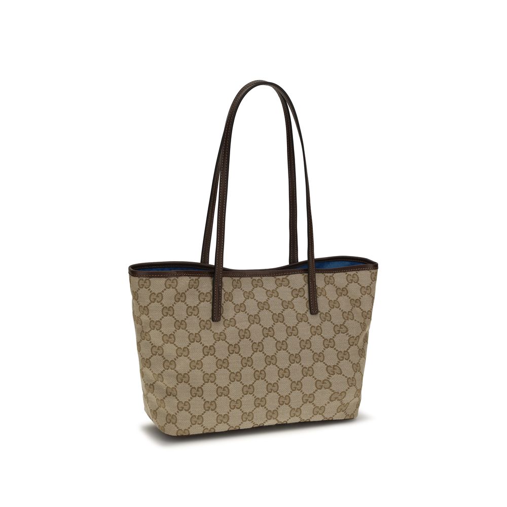 Sac à main en polyester beige de Gucci, élégant et spacieux, avec détails de luxe visibles sur le produit.