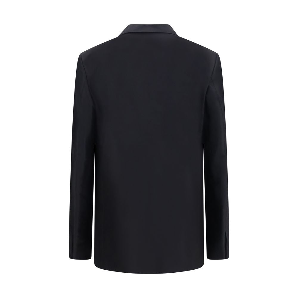 Veste en soie noire Gucci pour femme, coupe élégante avec détails sophistiqués, visible sur cette image.