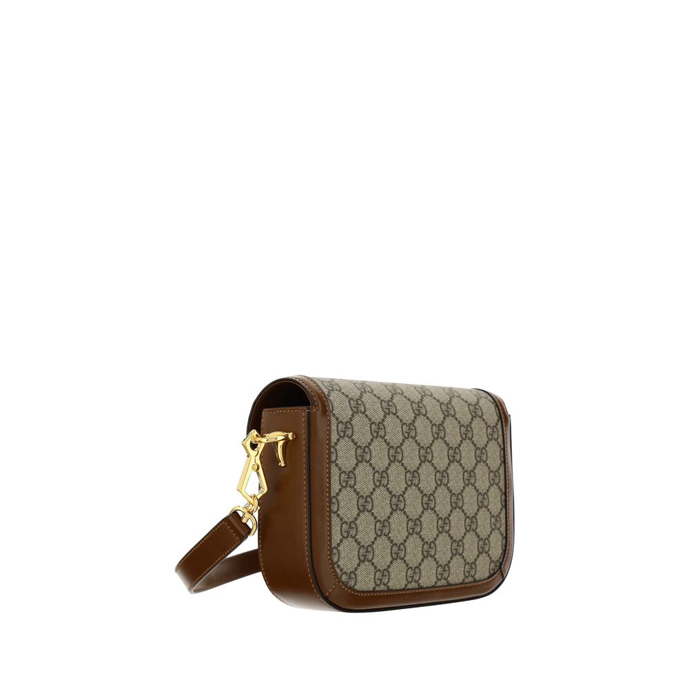 Sac à main Gucci en polyéthylène marron, élégant et moderne, avec poignées et logo Gucci visible.