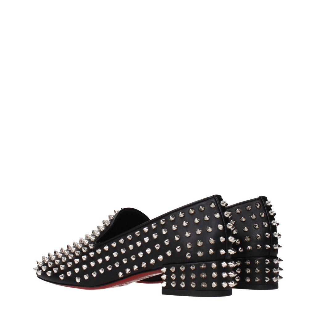 Chaussures mocassins Christian Louboutin en cuir noir, slip-on, avec semelle en cuir et détails élégants, pour homme.