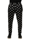 Pantalon homme Dolce & Gabbana en soie noire, coupe skinny, style pantalon élégant et ajusté, porté sur un mannequin.