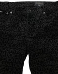 Jeans slim en denim noir Dolce & Gabbana avec logo monogramme en coton, coupe ajustée, détails élégants.
