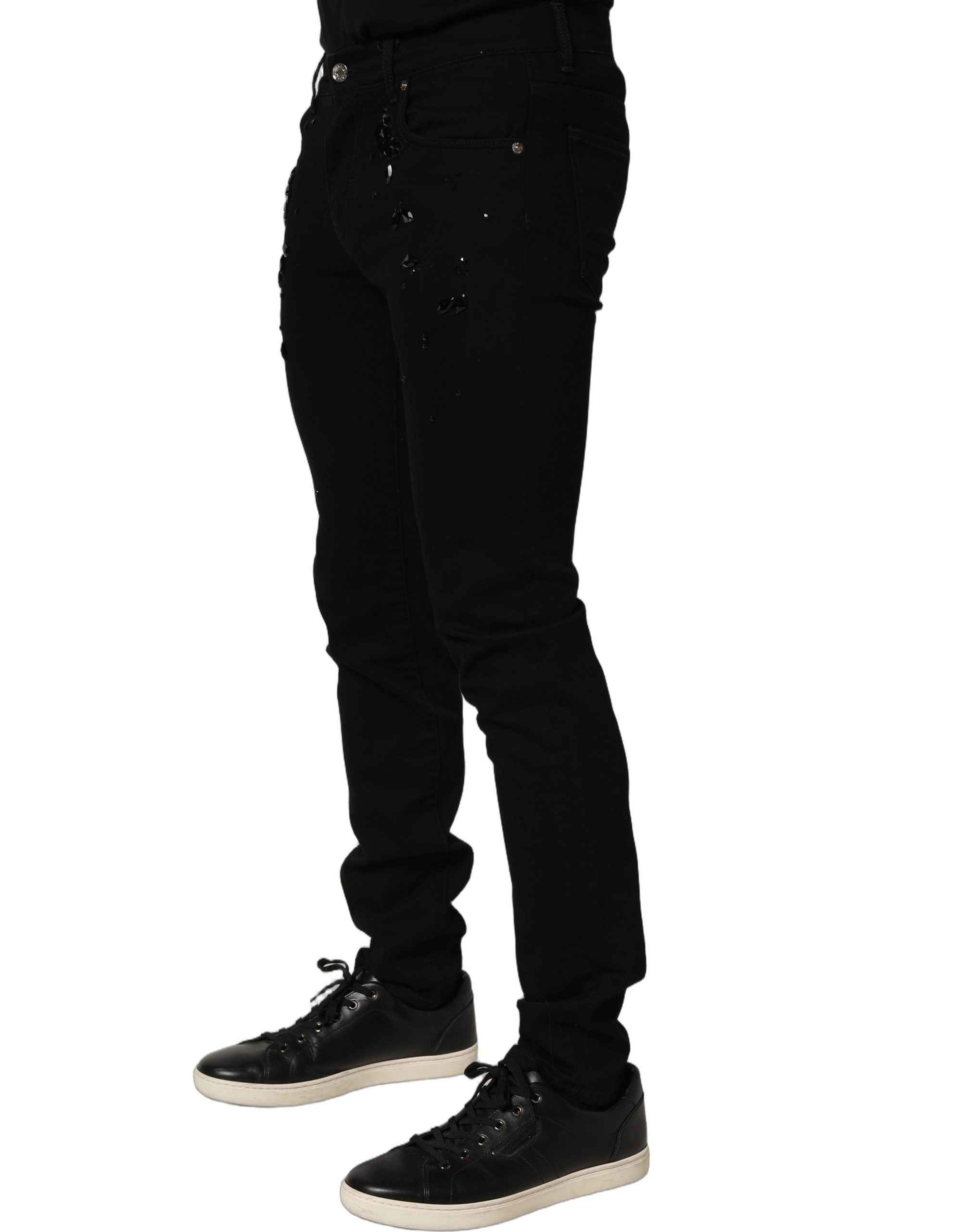 Jeans skinny en denim coton noir Dolce & Gabbana avec embellissements, visibles avec détails de broderies et finition élégante.