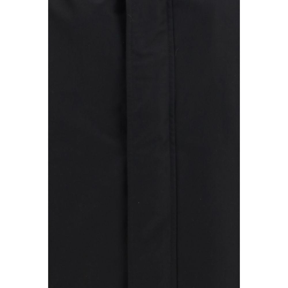 Veste longue en coton noir de Gucci, style élégant et moderne, visible avec détails de la marque Gucci.