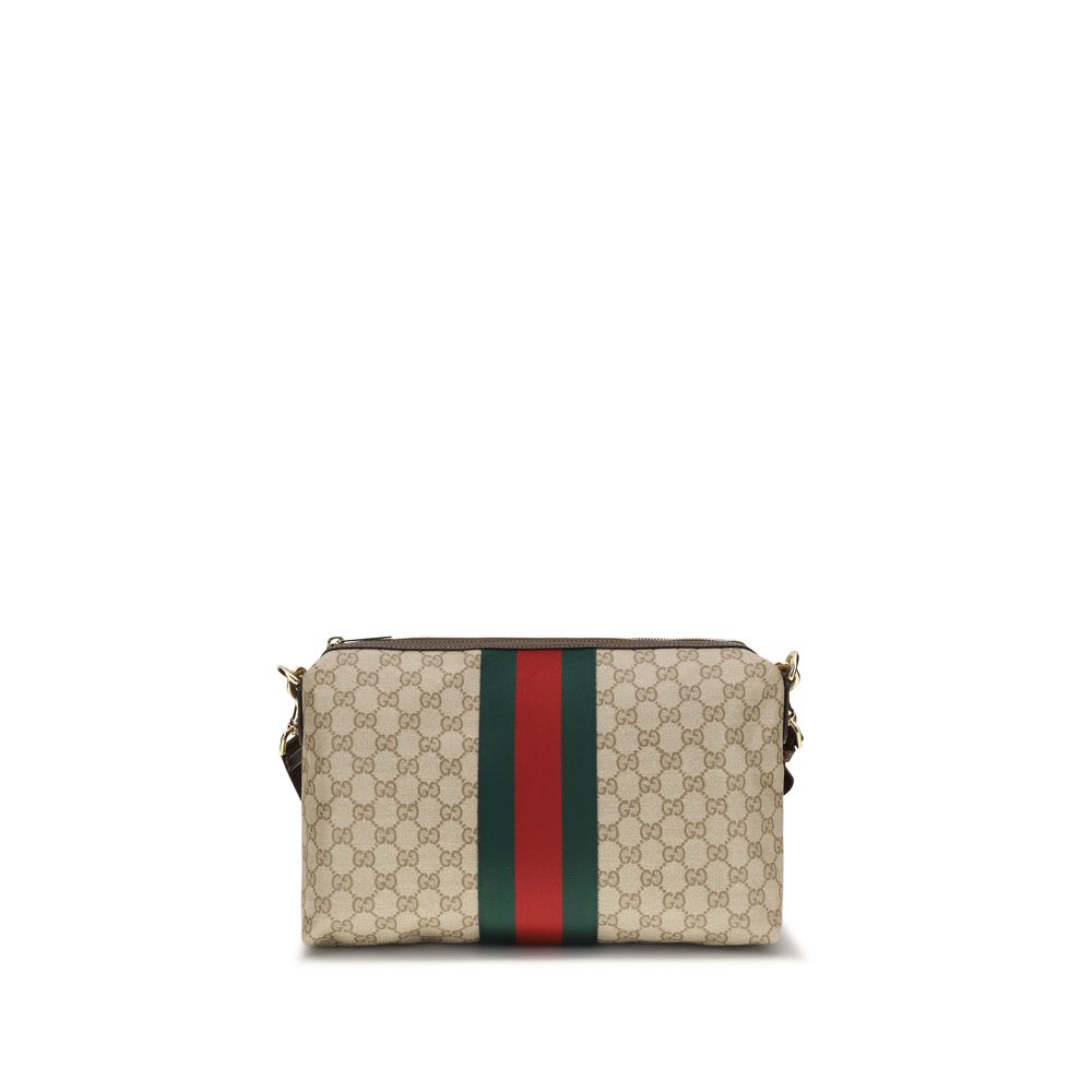 Sac à bandoulière en coton beige Gucci, sac à main élégant avec logo Gucci visible sur le devant.