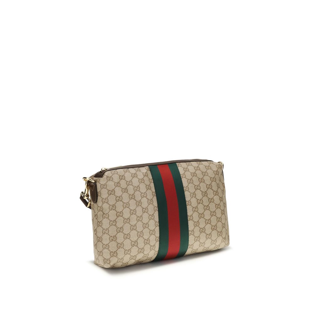 Sac à bandoulière en coton beige de Gucci, avec logo emblématique, visible dans une image claire et détaillée.