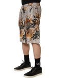 Shorts bermuda en soie beige à imprimé floral pour homme de Dolce & Gabbana, détails élégants et tissu léger.