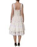 Robe midi en coton blanc avec volants de Dolce & Gabbana, style élégant et féminin, visible avec détails de volants en tissu léger.