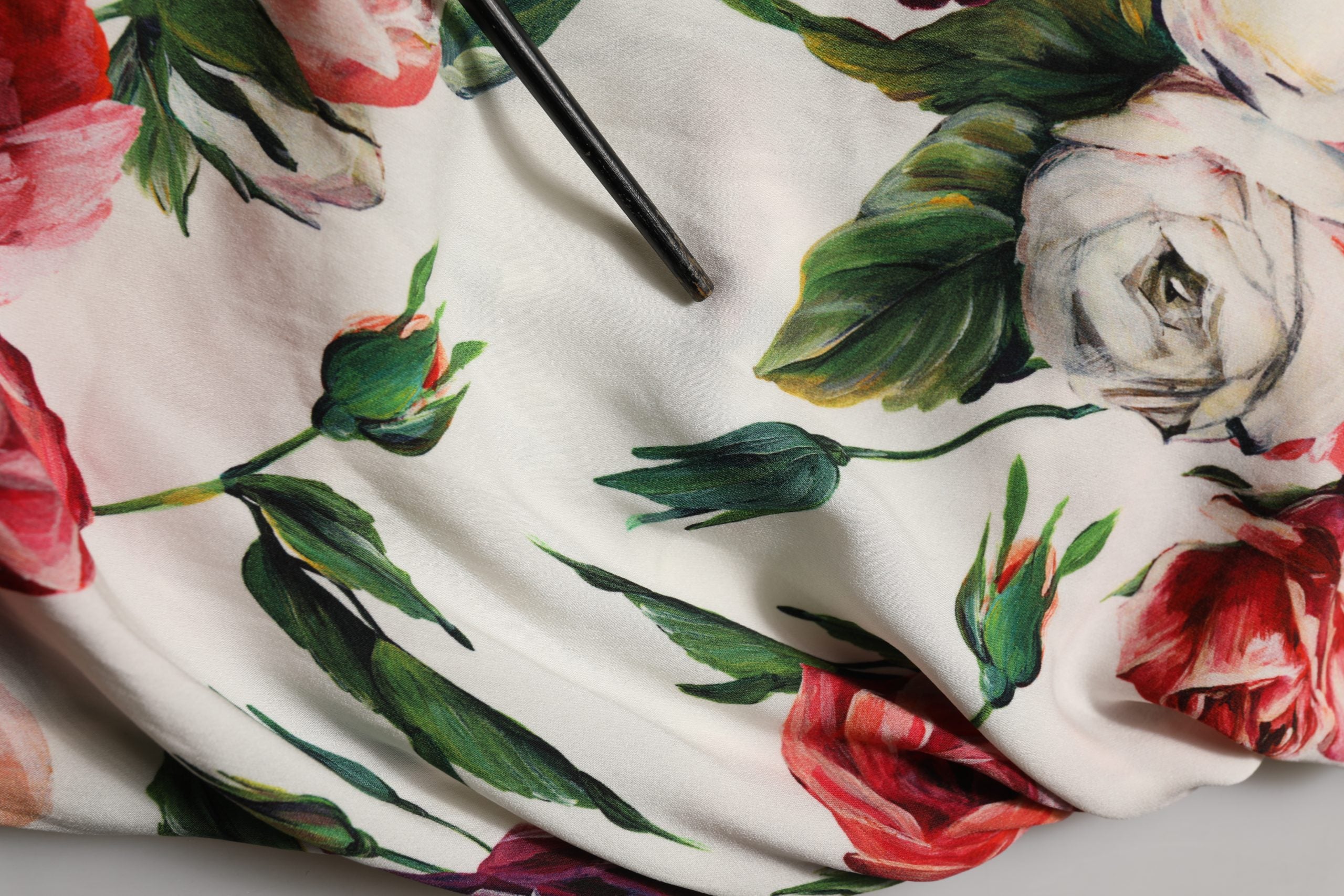 Robe courte blanche sans manches Dolce & Gabbana avec motif floral, coupe ajustée et élégante, idéale pour une tenue chic.