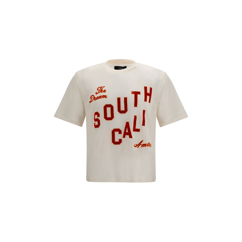 T-shirt en coton beige de la marque Amiri, coupe classique avec col rond, illustration discrète sur le devant.