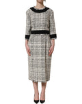Robe midi en tweed multicolore Dolce & Gabbana avec finition frangée, élégante et sophistiquée, visible en détail sur l'image.