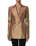 Veste blazer Dolce & Gabbana en soie dorée, à double boutonnage, élégante et sophistiquée, portée ouverte sur fond neutre.