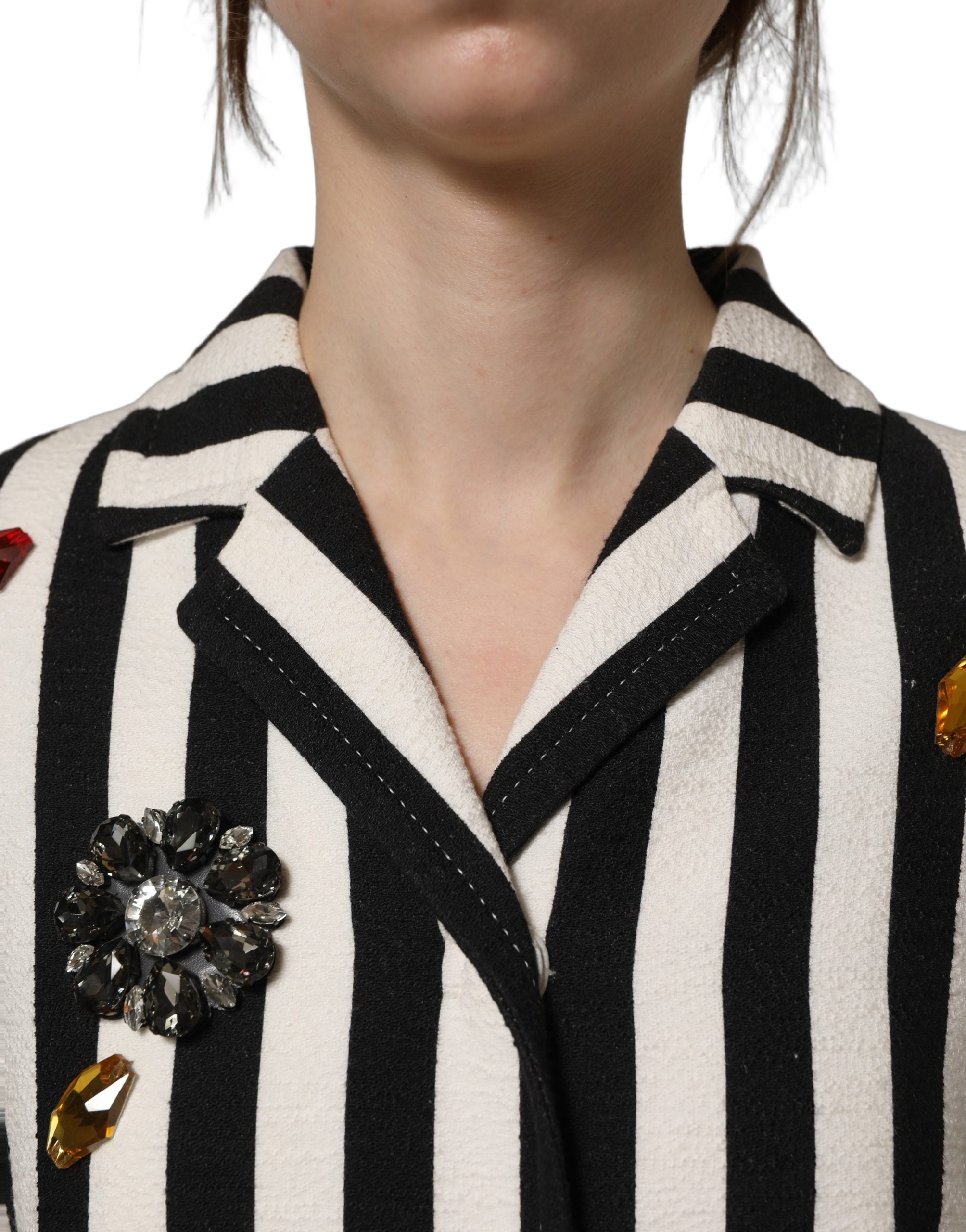 Manteau Dolce & Gabbana noir et blanc à rayures avec embellissements, coupe élégante et détails sophistiqués.