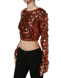 Blouse courte Dolce & Gabbana rouge à sequins à manches longues, style élégant et sophistiqué, porté sur mannequin.
