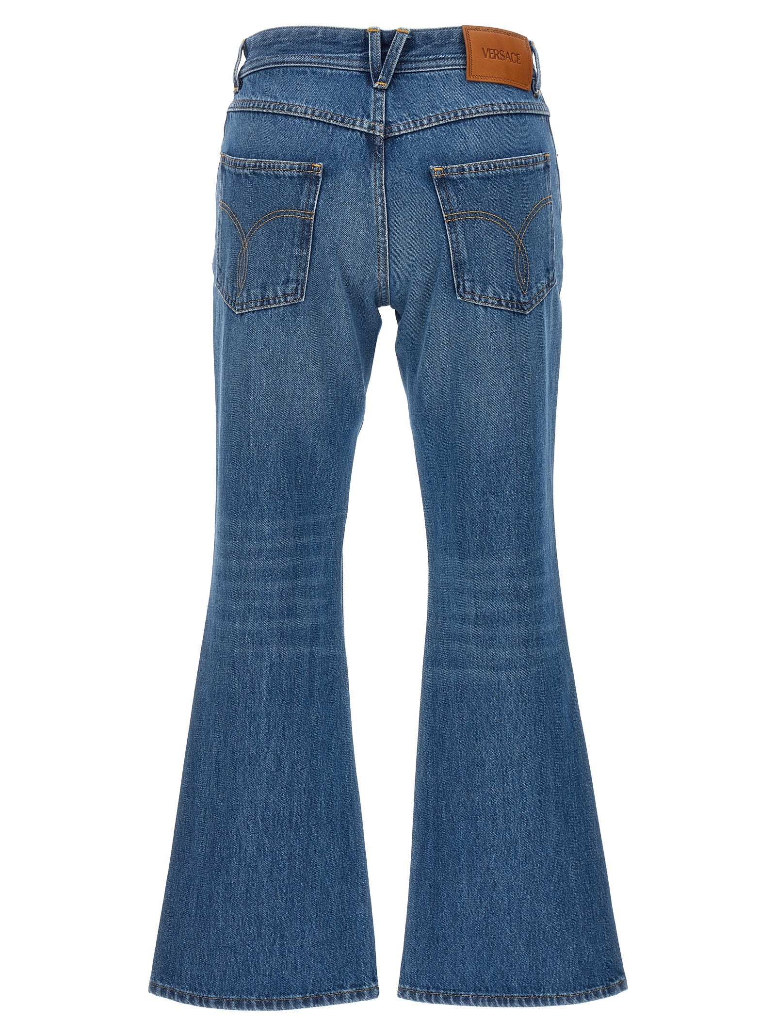 Jeans évasés en coton bleu de la marque Versace, avec coupe large et détails de style moderne.