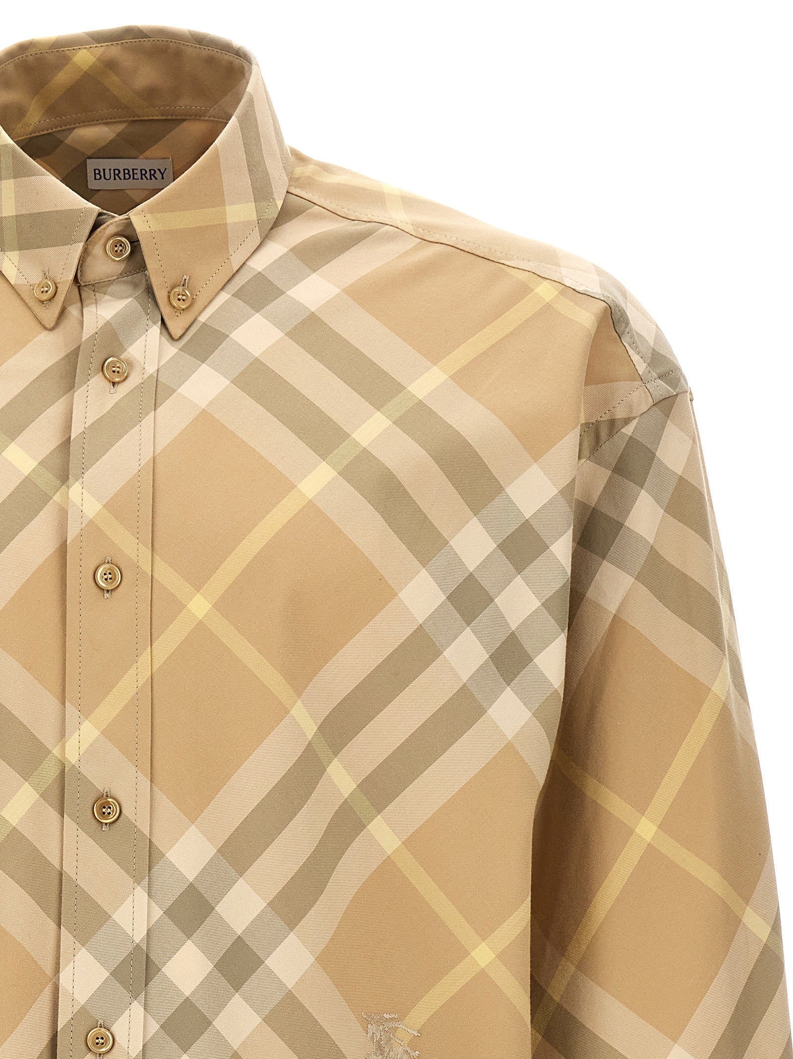 Blouse en coton beige de marque Burberry, élégante et décontractée, avec détails classiques visibles sur l'image.