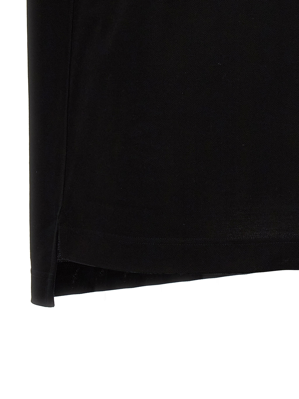 Chemise polo noire en coton de la marque Givenchy, vue de face avec col et boutons visibles.