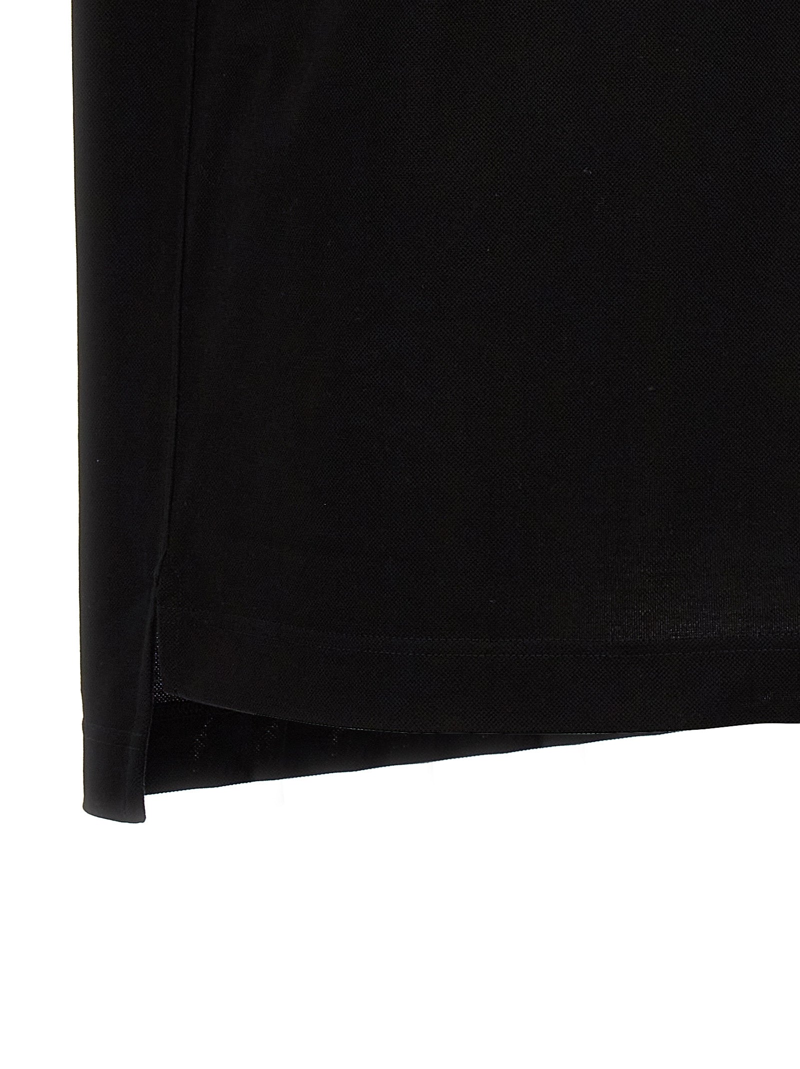 Chemise polo noire en coton de la marque Givenchy, vue de face avec col et boutons visibles.