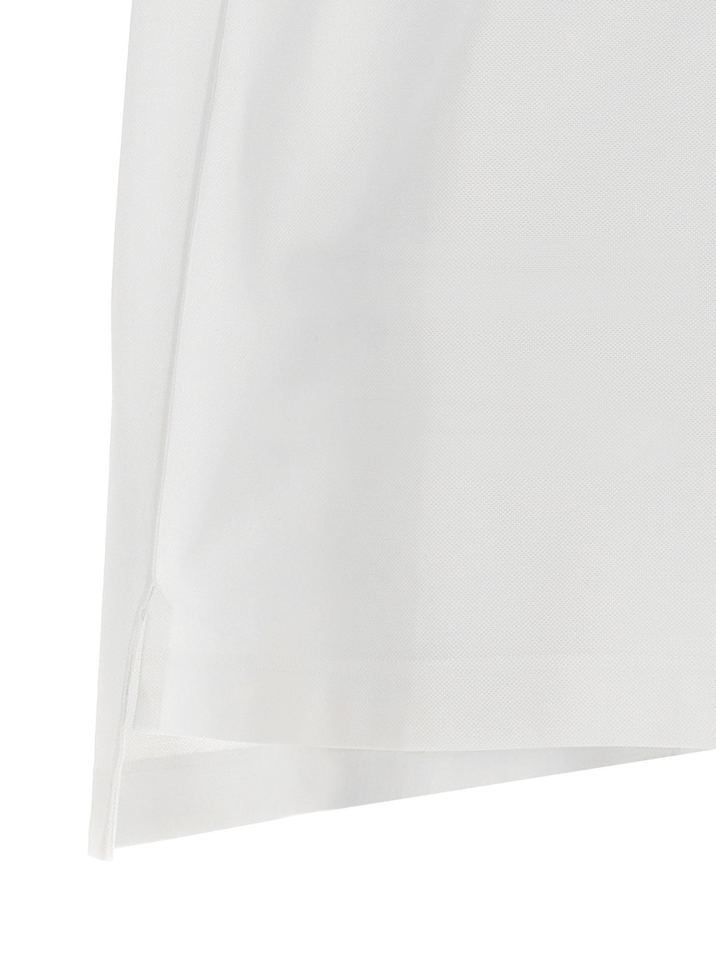 Chemise polo blanche en coton Givenchy, vue de face, avec col classique et logo discret sur la poitrine.
