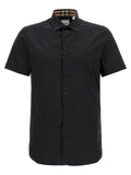 Blouse en coton noir de Burberry, coupe classique avec logo subtil, portée décontractée ou élégante.
