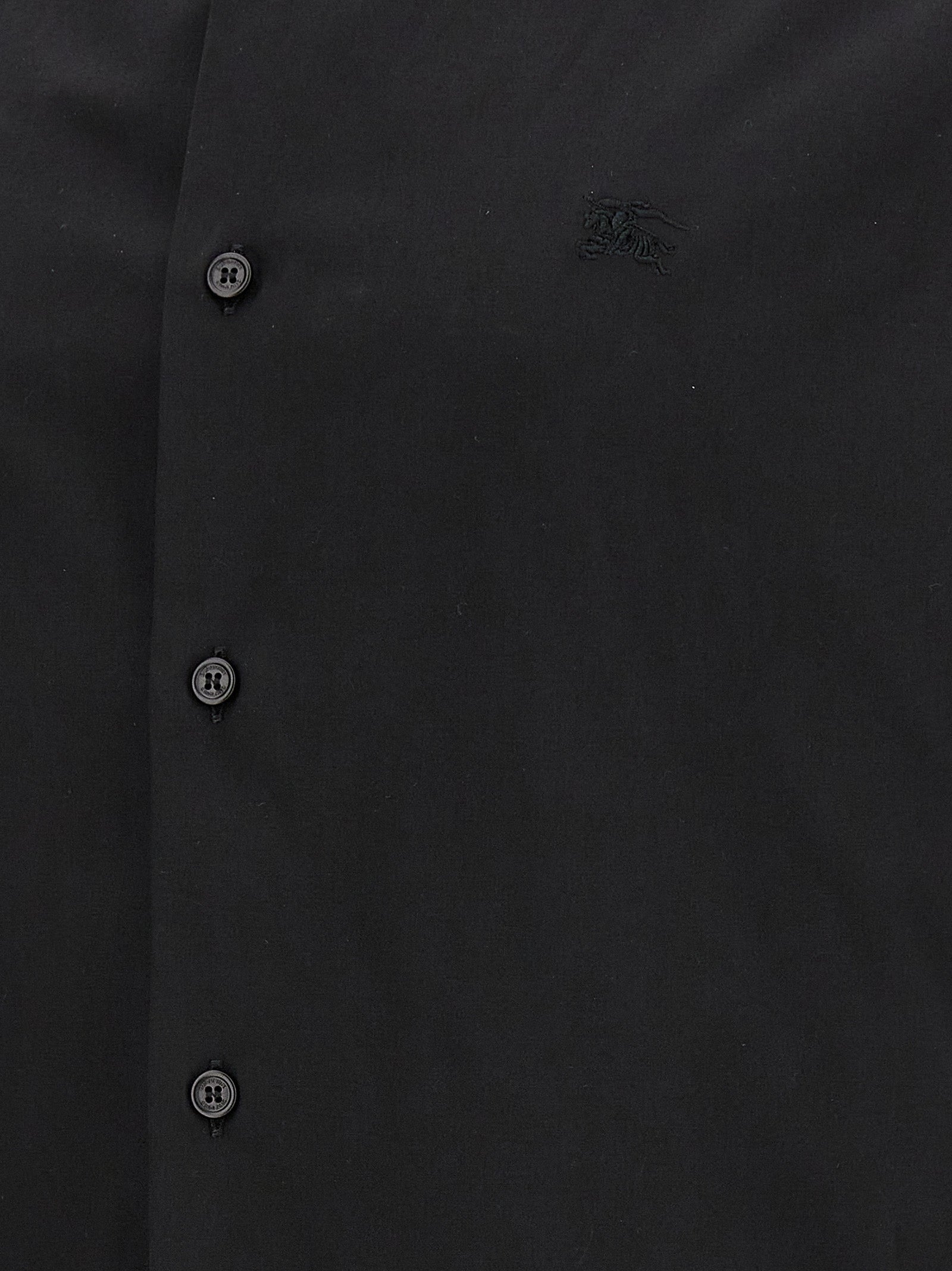 Chemise en coton noir Burberry, style classique, avec col et manches longues, portée décontractée.
