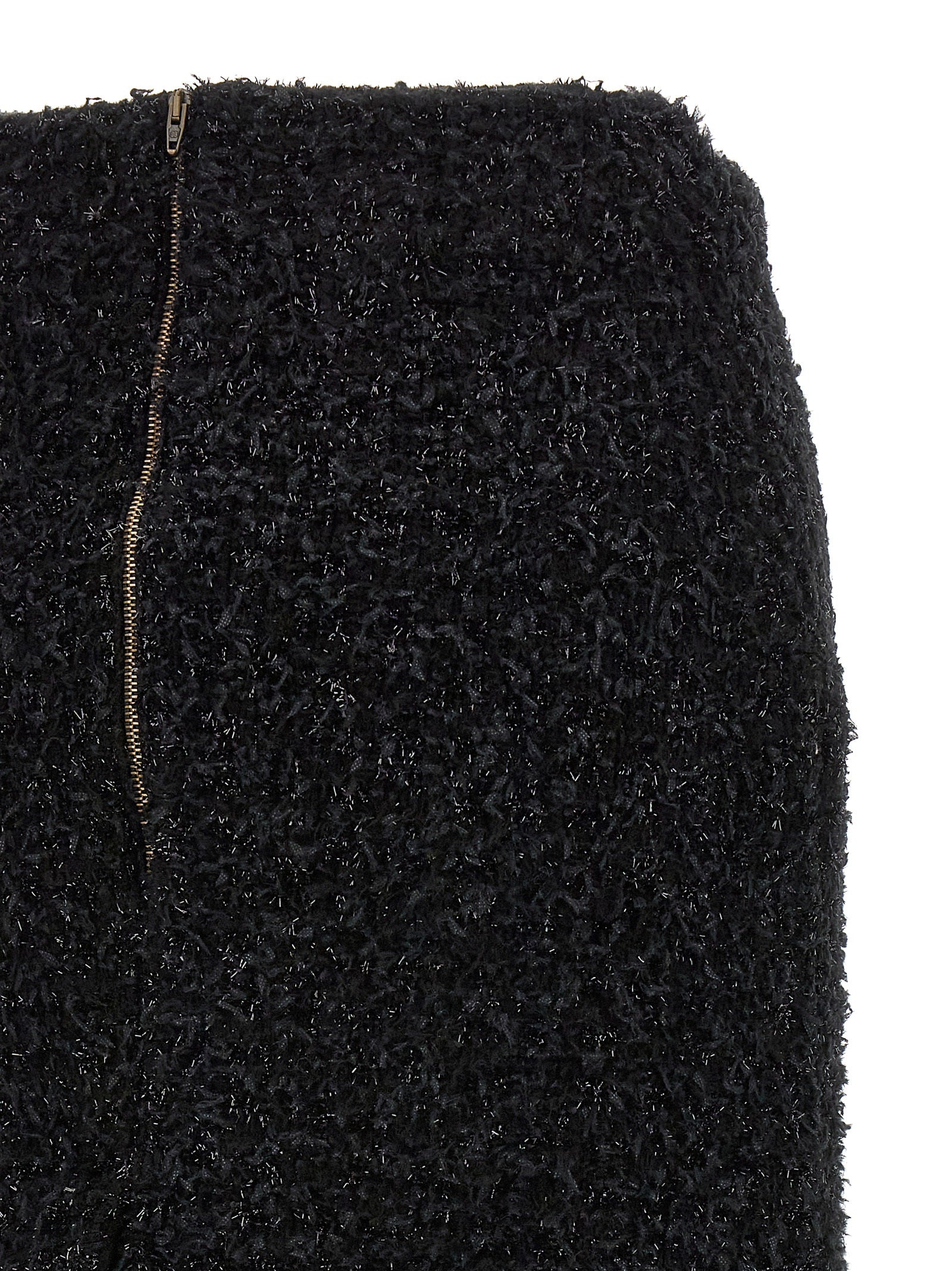 Jupe midi en coton noir de Balenciaga, élégante et structurée, avec coupe fluide et détails modernes visible dans l'image.
