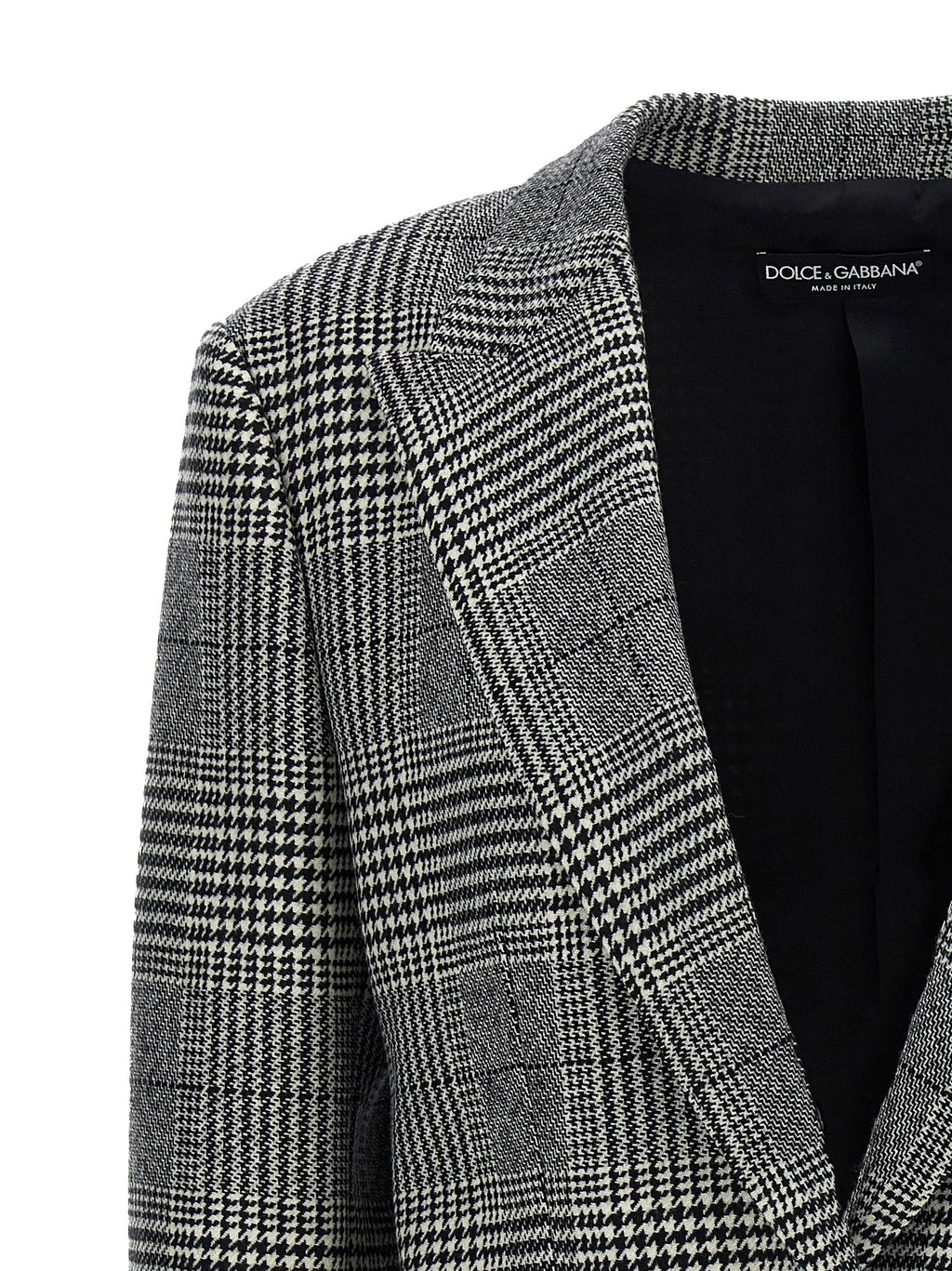 Blazer en laine bicolore Dolce & Gabbana, coupe élégante avec revers et boutons, porté sur un mannequin.