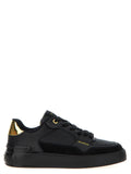 Sneakers noires en veau, style Balmain, avec détails élégants en cuir et semelle blanche, pour un look tendance et sophistiqué.