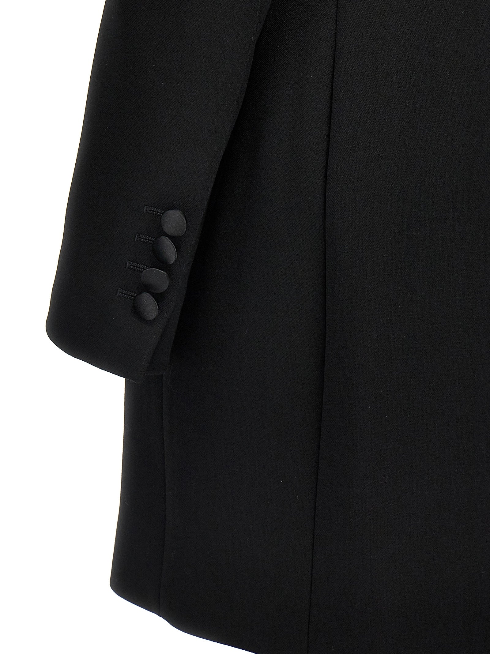 Veste blazer en laine vierge noire de Dolce & Gabbana, coupe élégante et moderne, portée sur un fond neutre.