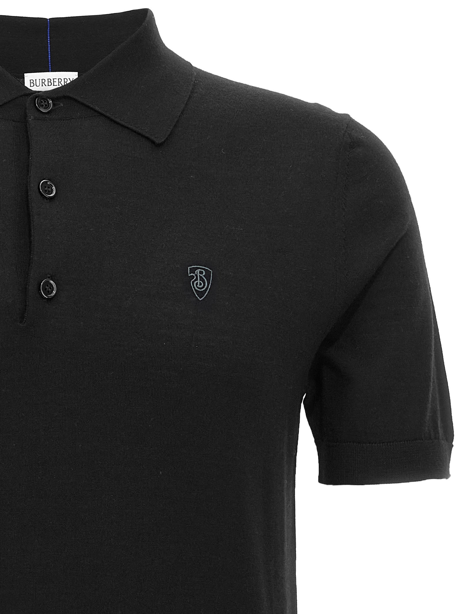 Polo en laine noire de Burberry, chemise classique avec col et boutons, tissu doux et élégant.
