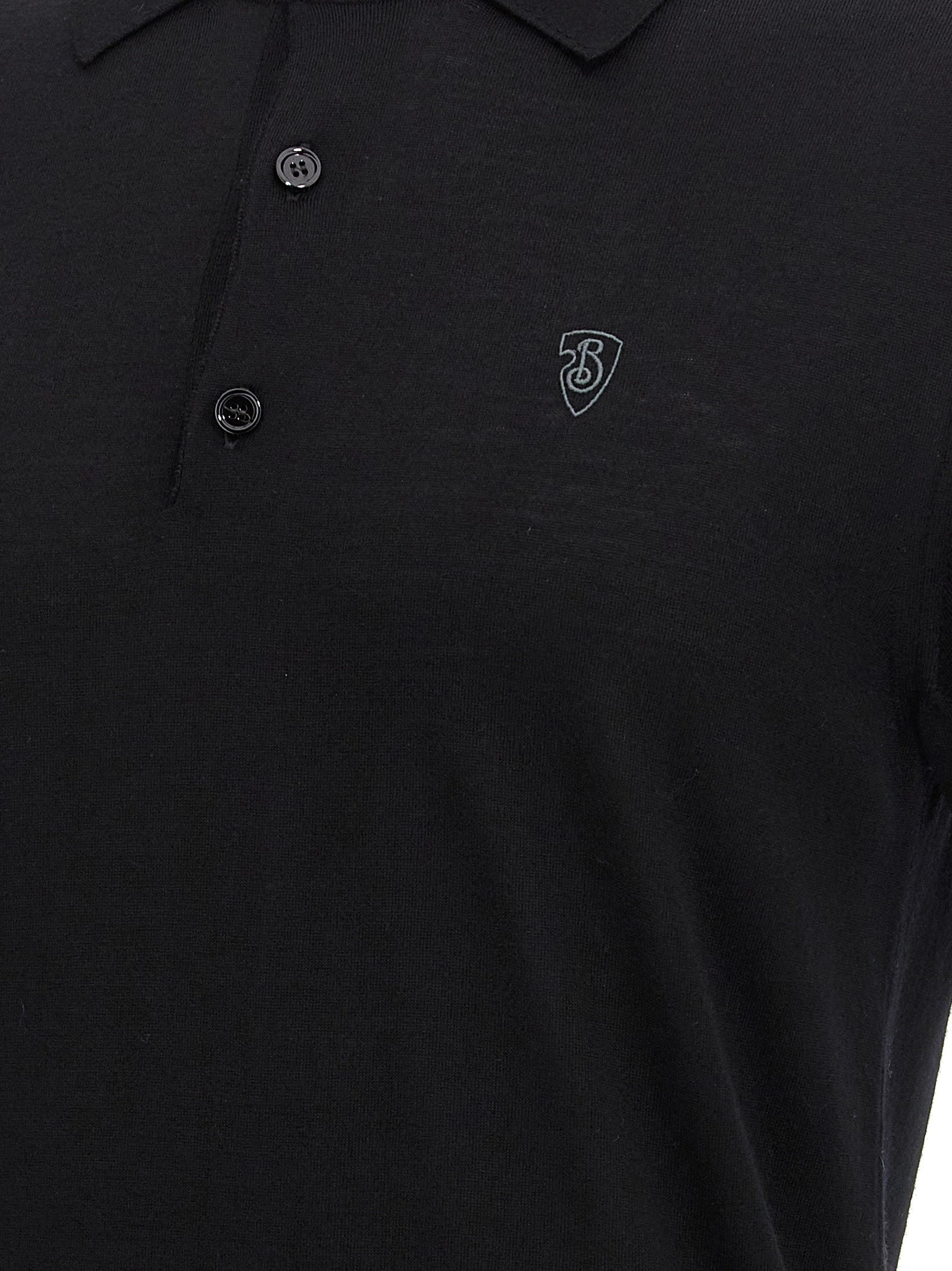 Chemise polo en laine noire Burberry, détail du col et logo emblématique sur la poitrine, vue de face.