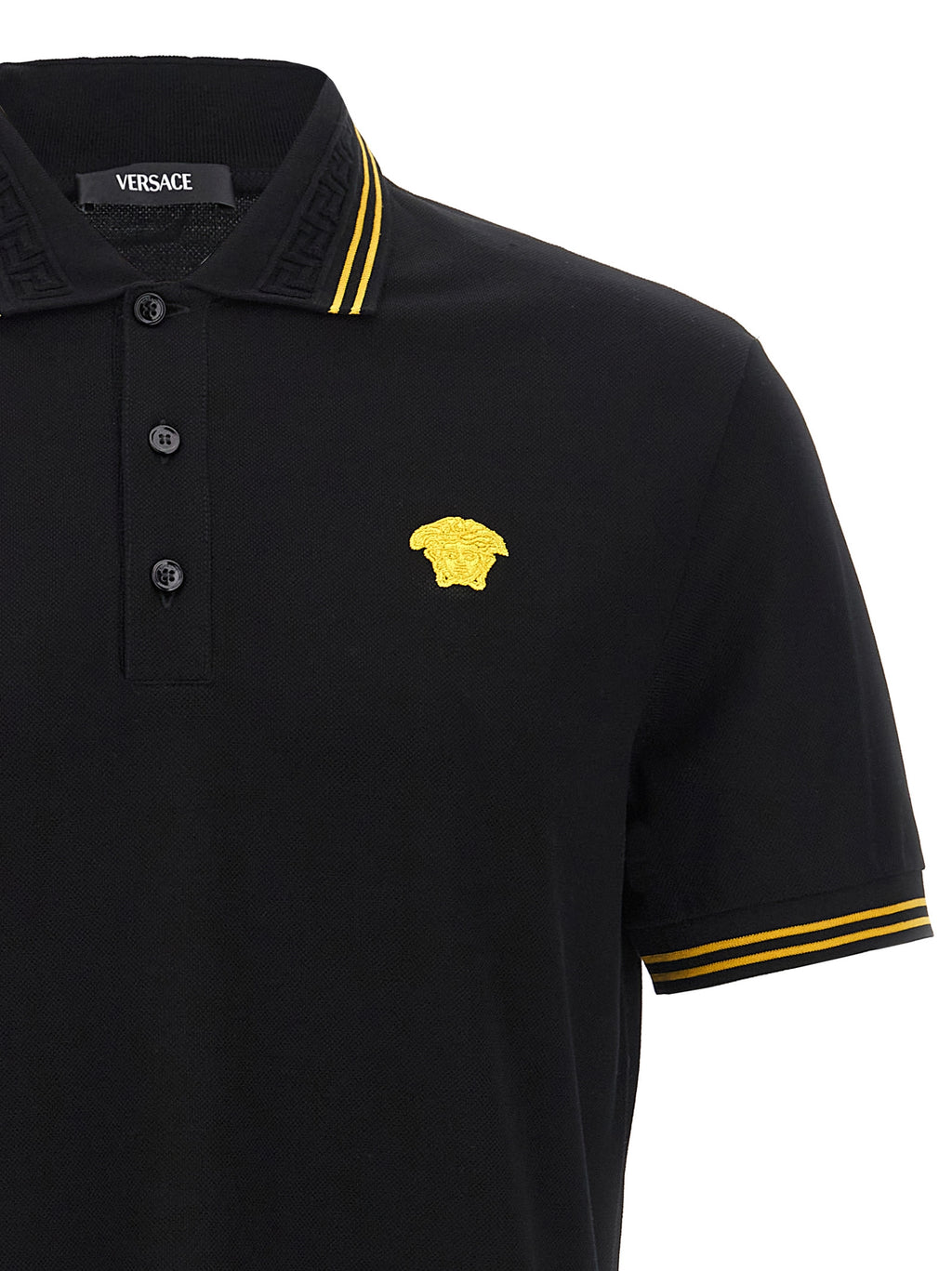 Chemise polo noire en coton de la marque Versace, avec logo emblématique visible sur la poitrine.