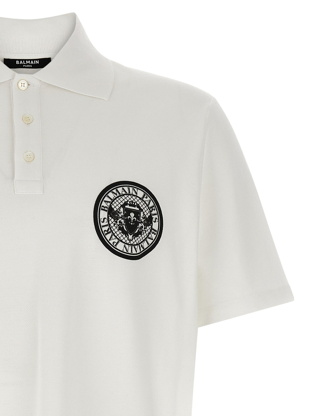 Chemise polo en coton bicolore Balmain, avec col contrastant et logo brodé, vue de face.