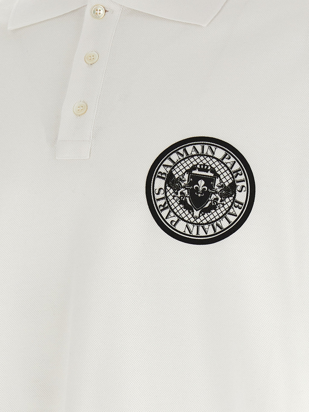 Chemise polo en coton bicolore Balmain, avec col classique et logo discret, vue en gros plan.