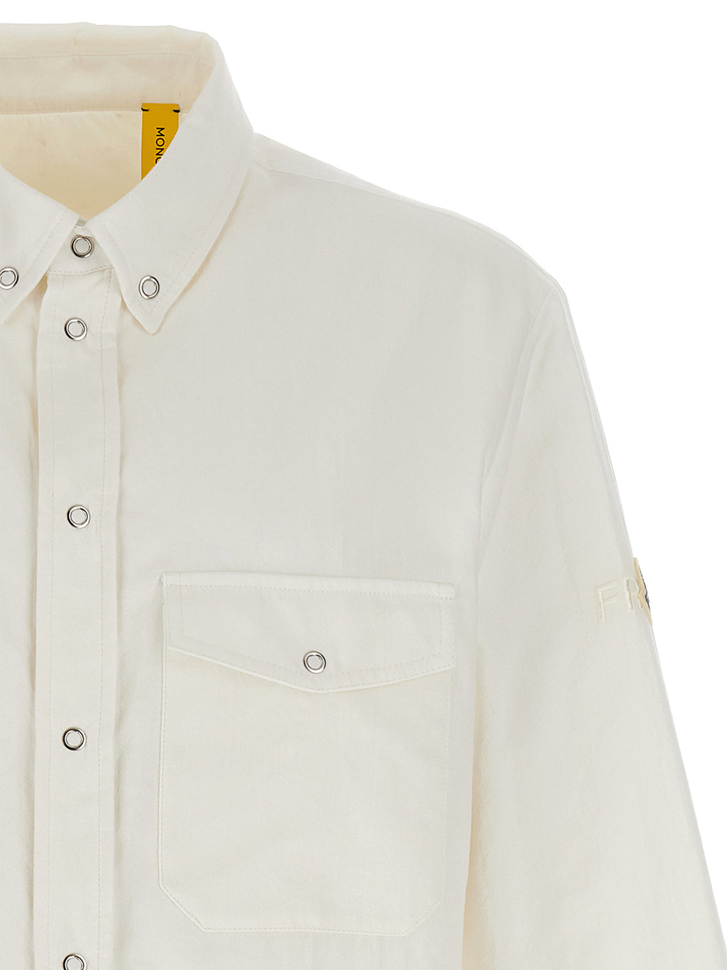 Blouse en polyamide blanche de la marque MONCLER GENIUS, avec détails élégants et coupe moderne visible sur l'image.