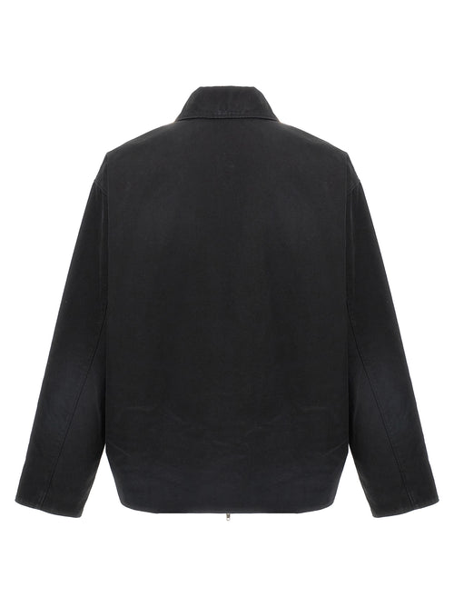 Veste longue en coton noir de Balenciaga, style moderne et élégante, visible en détail sur l'image.