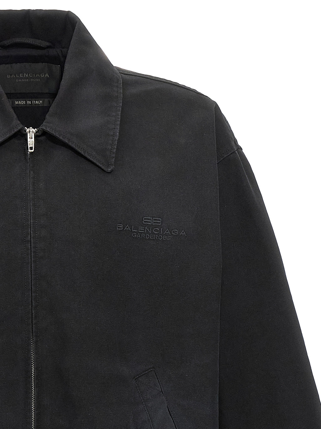 Veste longue en coton noir de Balenciaga, vue de face, avec détails de couture et fermeture éclair visible.