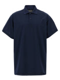 Chemise polo en coton bleu de la marque Balenciaga, avec col classique et logo discret sur la poitrine.