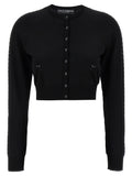 Cardigan noir en viscose de Dolce & Gabbana, détail élégant avec boutons et col classique, porté en style décontracté.
