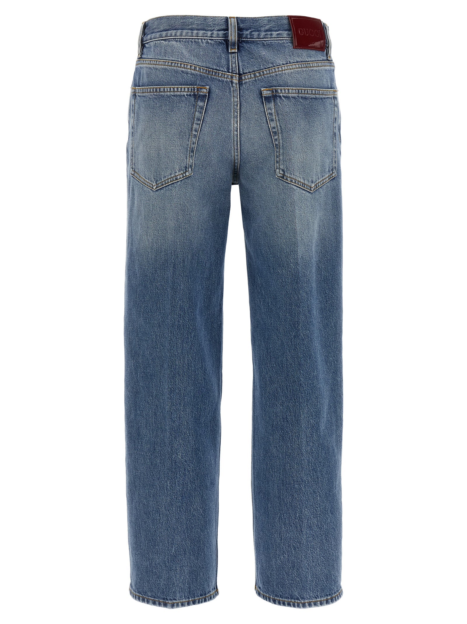 Jeans droits en coton bleu de Gucci, vue en gros plan, détails du tissu et coupe droite.